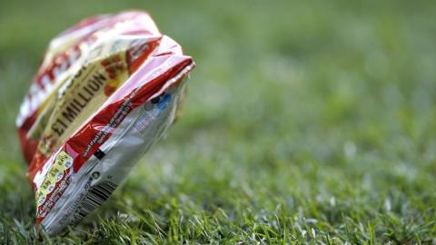 Crisp packet on football pitch