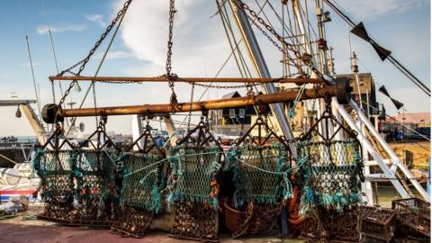 weighted nets on a scallop fishing boat