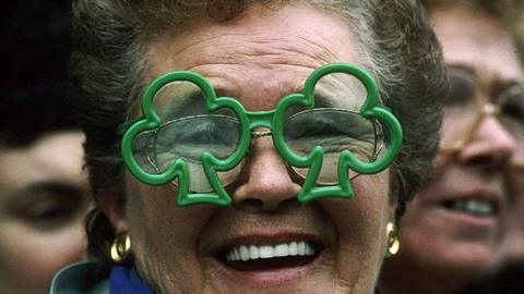 Woman with green glasses watches 1998 St Patrick's day parade, Dublin