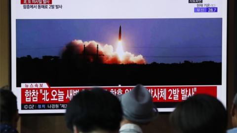 South Koreans watch TV report about North Korea's missile test, at Seoul station in Seoul, 10 August 2019