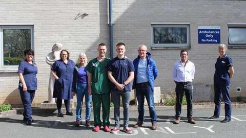 Tom with NICU staff outside the hospital