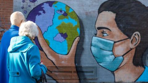 A nurse holding a globe is painted near the vaccine centre