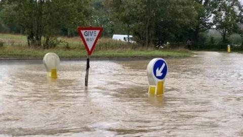 High flood waters around street signs