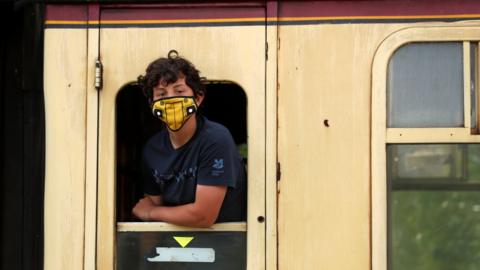 boy on train wearing mask