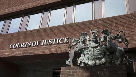 Outside Portsmouth Crown Court. A brown brick building with the words COURTS OF JUSTICE written on the front