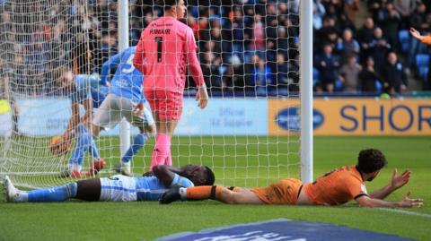 Ephron Mason-Clark lies full length after catching himself in the face scoring Coventry's equaliser against Hull City