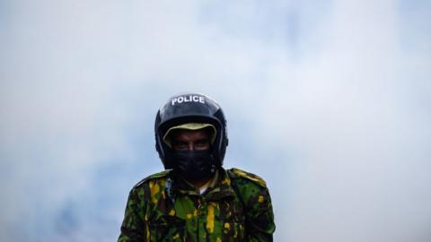 Police officer surrounded by smoke