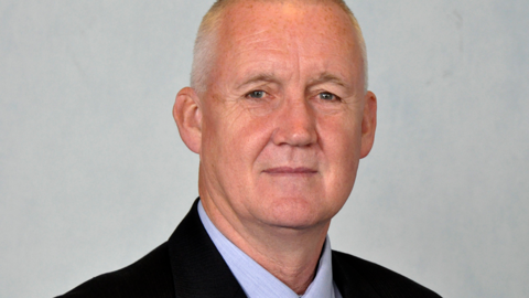 Council publicity photo shows head and shoulders shot of Garry Burchett in front of neutral background