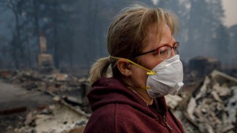 Woman wearing a smoke mask in northern California after deadly fires