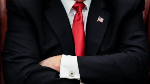 Donald Trump folds his arms
