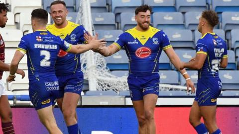 Matty Ashton celebrates his first try with his Warrington Wolves team-mates.