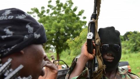 A mutinous soldier wearing hood holds a weapon inside a military camp in the Ivory Coast"s central second city Bouake, on May 15, 2017.