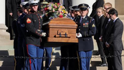 Members of the military carry Rosalynn Carter's casket.