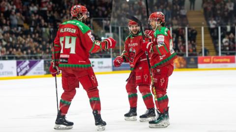 Joey Martin celebrates his goal with Brandon Alderson and Marcus Crawford