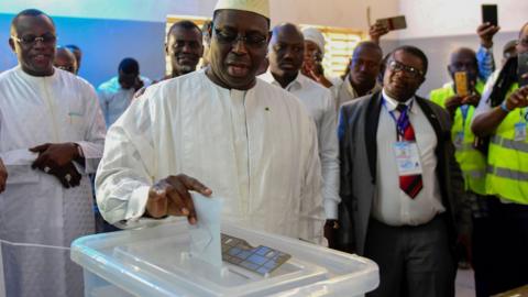 Incumbent President Macky Sall casts his vote for Senegal's presidential elections in a ballot box at a polling station in Fatick on February 24, 2019