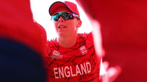 Heather Knight of England speaks to their side in the huddle during a warm-up match