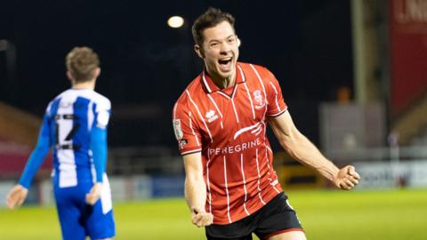 Tom Hopper celebrates for Lincoln