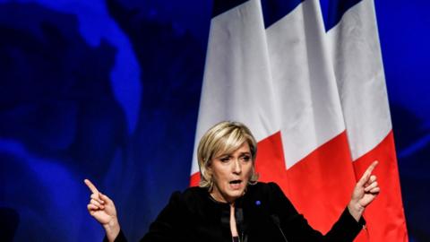 Marine Le Pen gestures as she speaks during a conference in Lyon, France, Sunday, 5 February