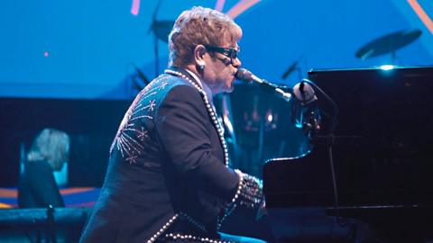 Elton John playing the piano