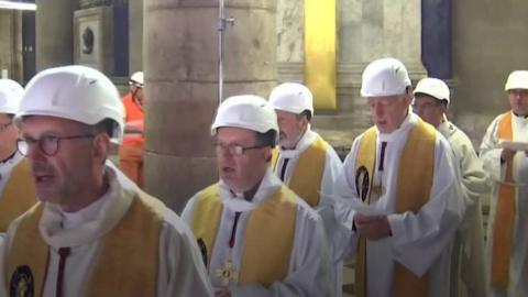 Priests in hard hats