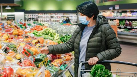 Woman wears a mask in a supermarket