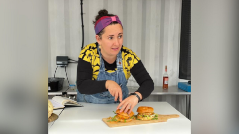 Eileen McKeown cutting a burger