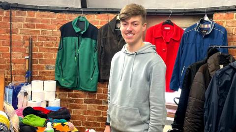 Wiltshire Wildlife Trust ambassador Kody stands in front of clothes