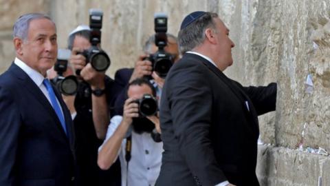 Israeli Prime Minister Benjamin Netanyahu (L) stands by as US Secretary of State Mike Pompeo (R) prays at the Western Wall in Jerusalem's Old City on 21 March 2019,