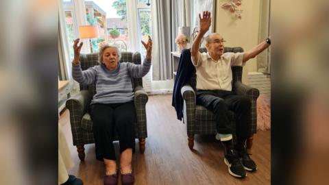 Care home residents exercising