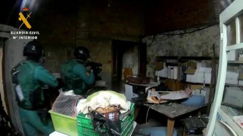 Spanish poliuce conduct a dawn raid on a property