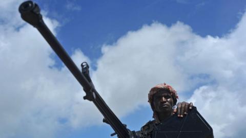 Somali soldier holds a machine gun at Sanguuni military base, where an US soldier was killed in a mortar attack on 8 June 2018