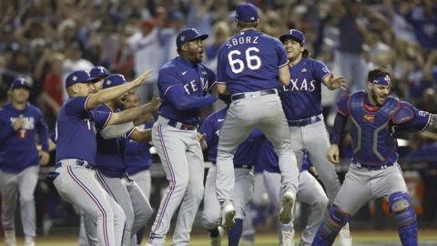 Texas Rangers players celebrate after Josh Sborz (centre) records the final out of the World Series