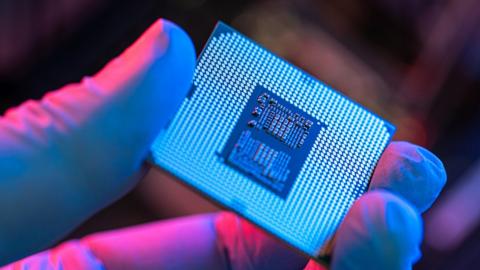 a semiconductor being held - stock photo