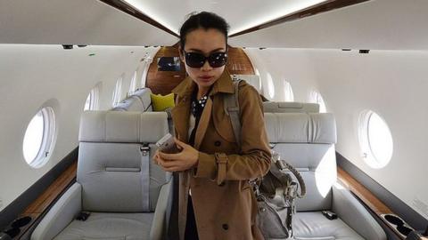 A Chinese woman on a luxury jet