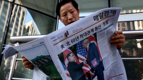 A South Korean man reads a newspaper in Seoul, Suth Korea, reporting President Trump's meeting with North Korean leader Kim Jonguun in June 2018