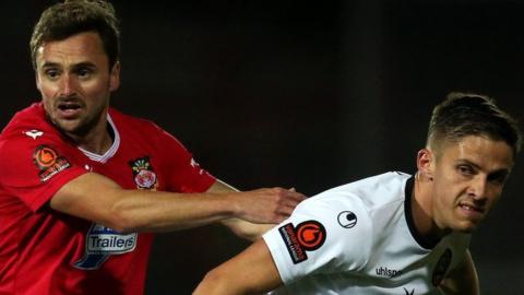 Paul Rutherford of Wrexham battles for possession Danilo Orsi-Dadomo