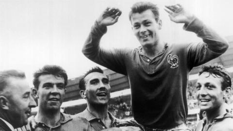 Just Fontaine being held aloft by his team-mates after finishing as top scorer at the 1958 World Cup