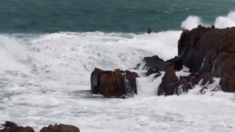 Waves crashing over rocks