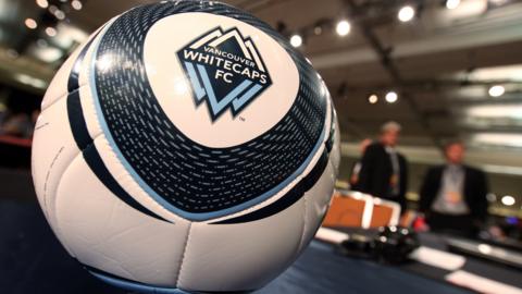A football with the Vancouver Whitecaps logo on it