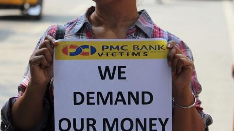 Woman protesting against PMC bank