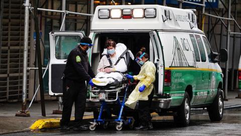 A patient is wheeled out of an ambulance to Mount Sinai West amid the Covid-19 pandemic