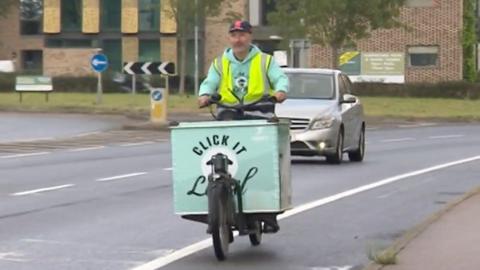 A Click It Local delivery person on a bike