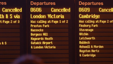 A train departure board at Brighton Station showing cancellations and disruption
