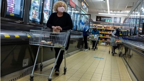 People shopping while wearing face masks