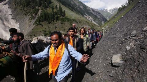 Indian Hindu pilgrims cross mountain trails during their religious journey to the Amarnath cave