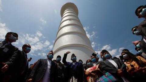 Nepal's Prime Minister KP Oli (C) waves during the inauguration of Dharahara tower, Kathmandu, 24 April