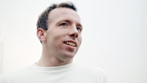 Former England and Manchester United player Nobby Stiles looks to the right