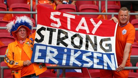 Dutch fans show their support for former Ajax midfielder Christian Eriksen, who collapsed on the pitch playing for Denmark at Euro 2020