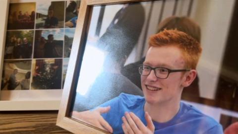 Framed photograph and photo album of Rory Shanahan