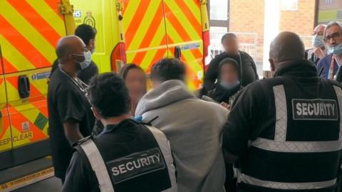 Security guards dealing with an aggressive patient